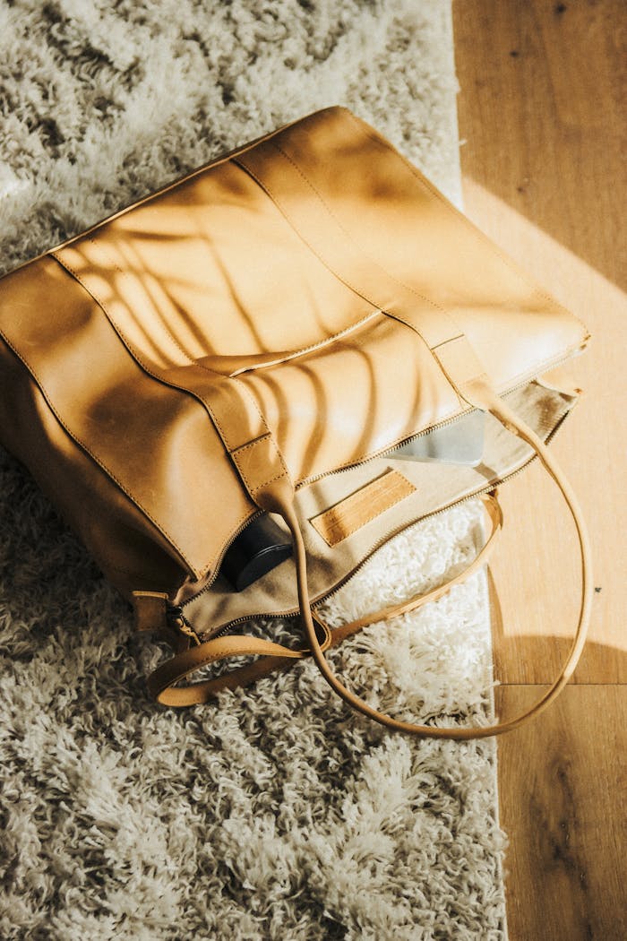 A stylish leather tote bag in sunlight, perfect for fashion and travel.